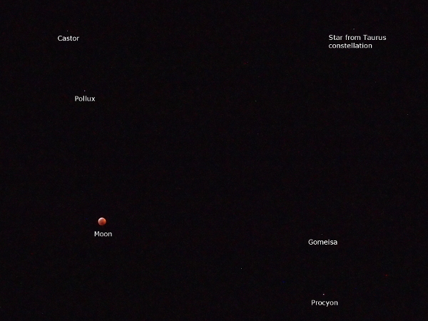 [This is the only Moon image on this page which is not a close view. This view of the sky has the Moon located in the lower left. Five tiny white dots and the Moon are all labeled. The stars Castor and Pollux are in the upper left. A star from the Taurus constellation is in the upper right. Gomeisa and Procyon are in the lower right.]
